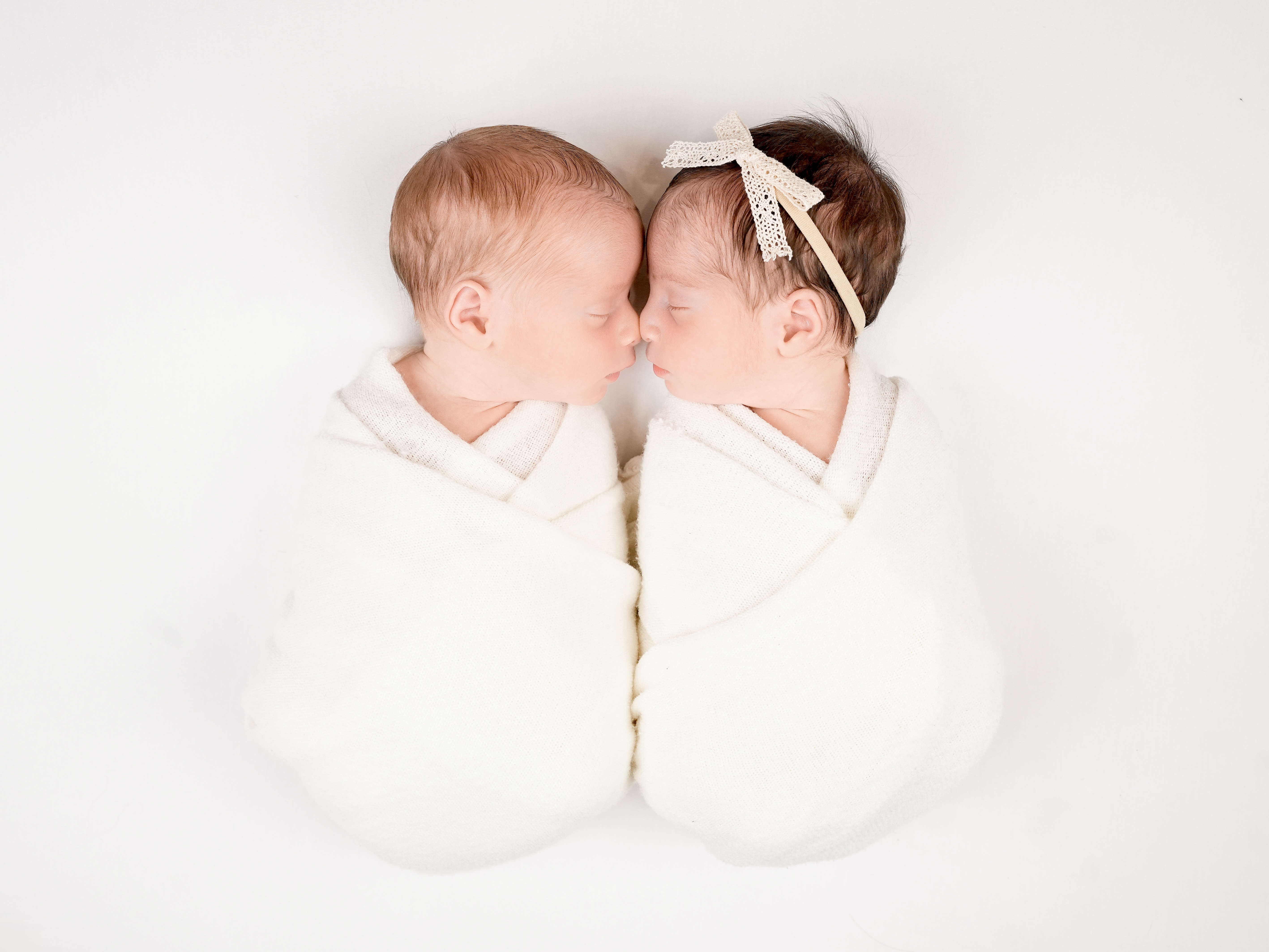 Twin newborns in matching wraps